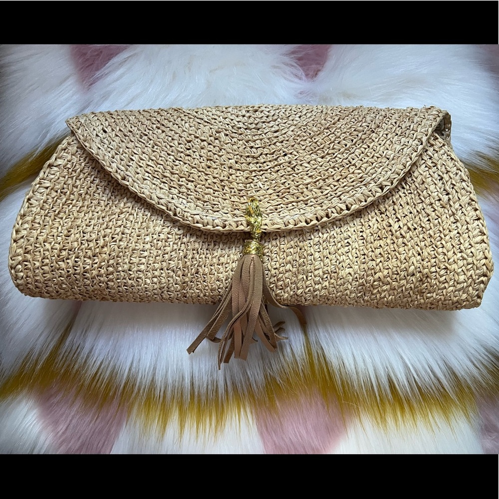 Tommy Bahama Islamora clutch with leather tassel in Natural. Magnetic snap .